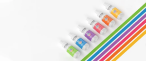 Row of colorful wellness supplement bottles arranged diagonally on a white background with matching rainbow stripes.