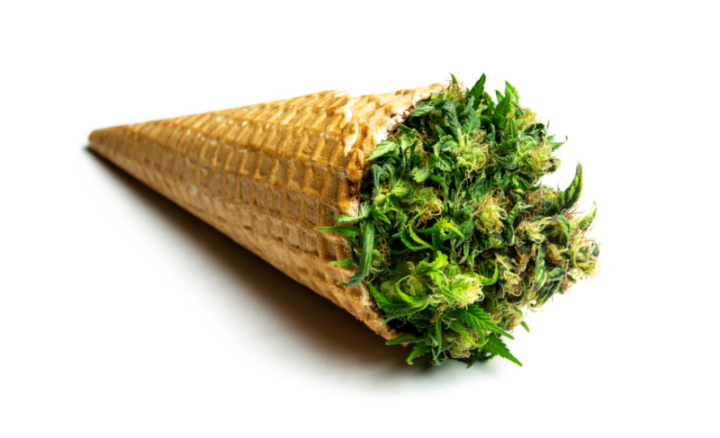 Cannabis flower packed inside a waffle cone, shown on a white background.