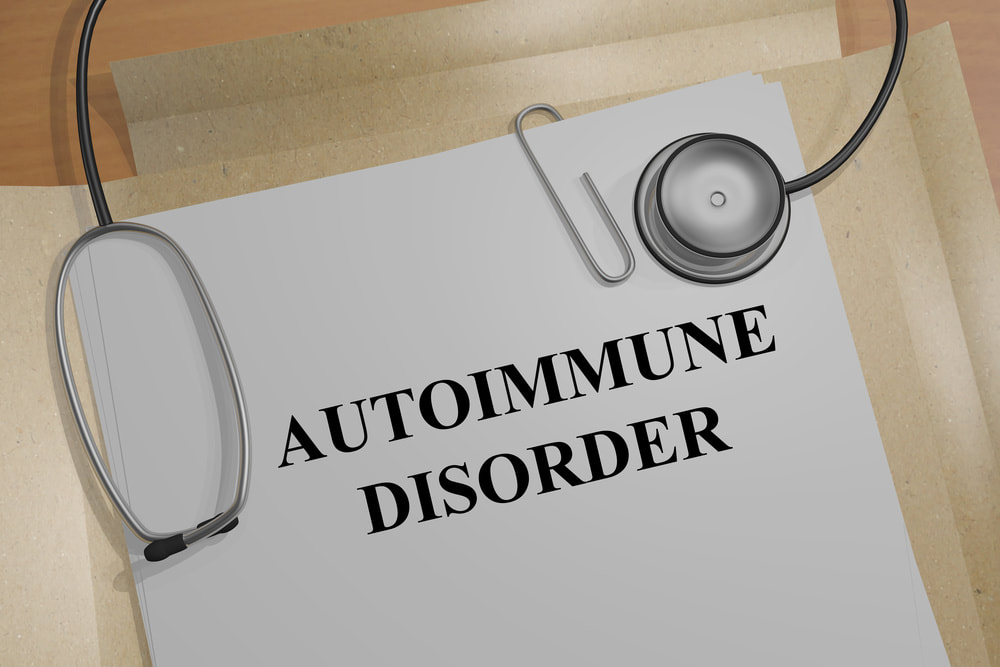 Document labeled Autoimmune Disorder on a desk with a stethoscope placed on top, representing a medical diagnosis concept.